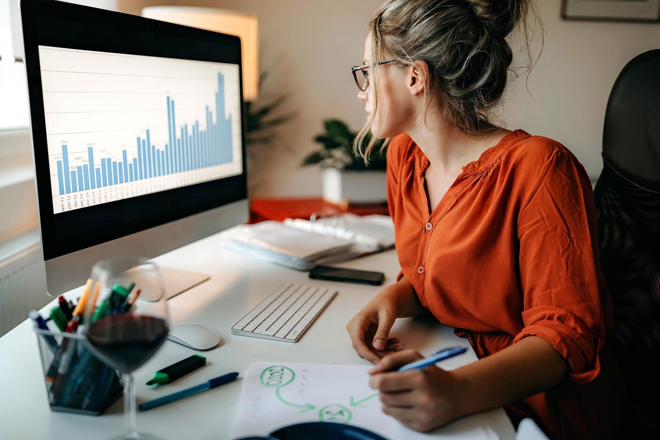 woman looking at data on the computer